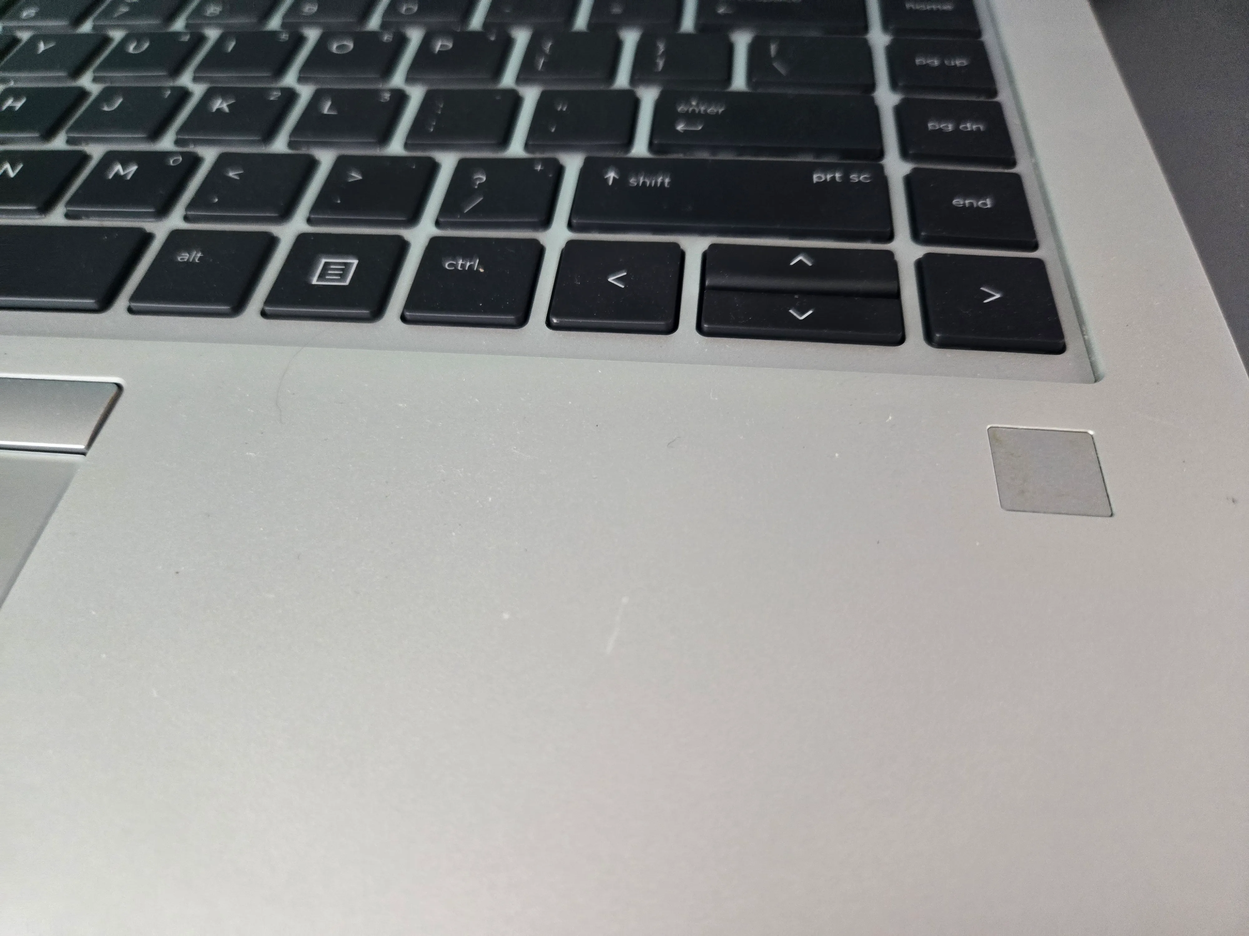 Laptop fingerprint sensor near trackpad
